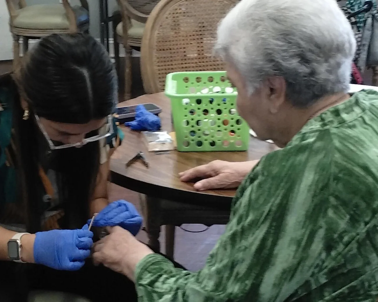 A staff member gives a resident hands-on nail care at Argent Court